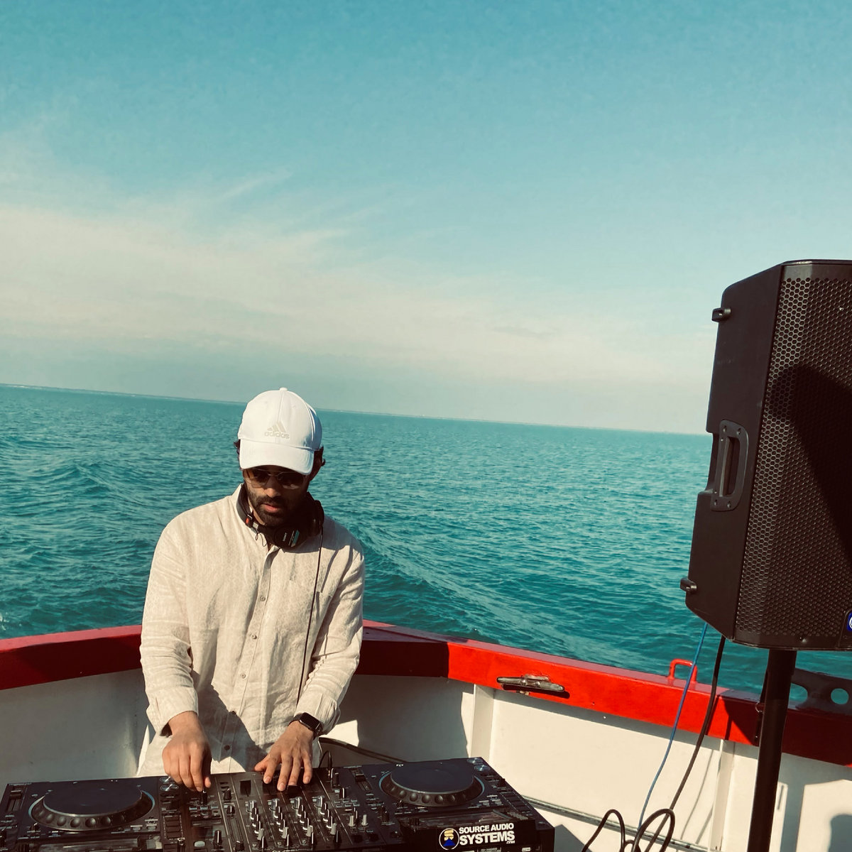 Mekato performing a DJ set on the water